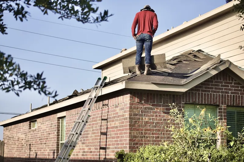 Professional roofer working on a residential roof in Rubicam
